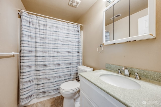 bathroom featuring a shower with shower curtain, tile patterned flooring, vanity, and toilet