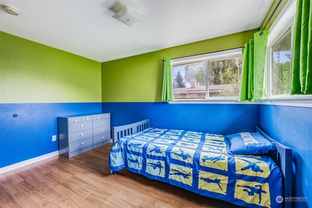 bedroom with light hardwood / wood-style flooring