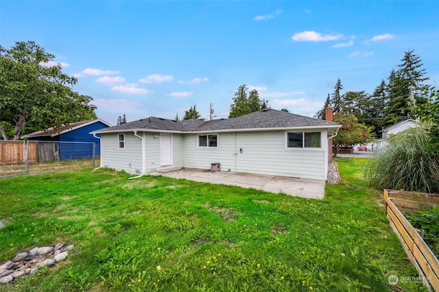 rear view of house with a yard and a patio area