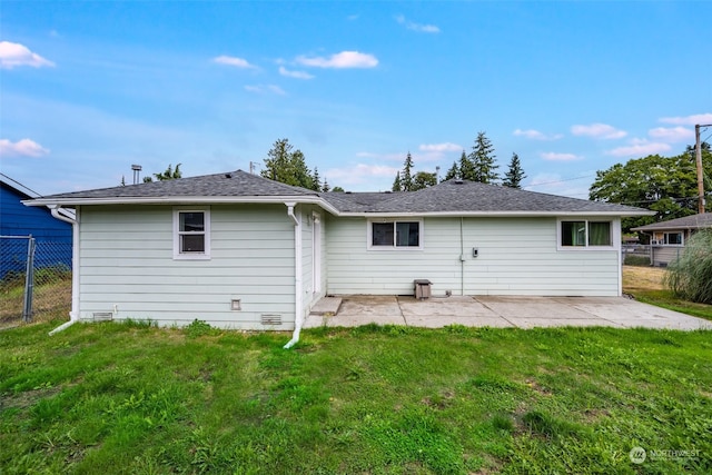 back of property featuring a lawn and a patio