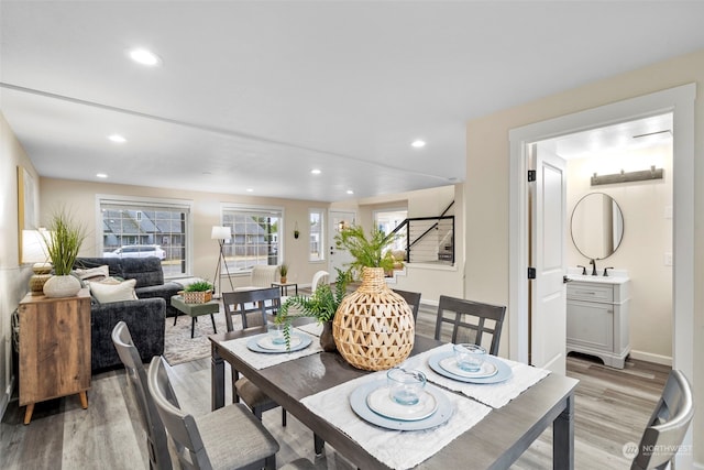 dining space with sink and light hardwood / wood-style floors