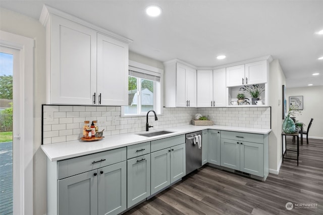 kitchen featuring dishwasher, tasteful backsplash, sink, dark hardwood / wood-style flooring, and gray cabinets