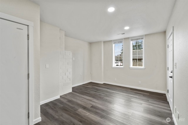 empty room with dark hardwood / wood-style flooring