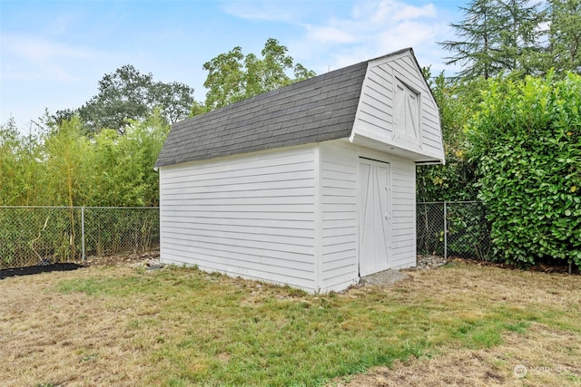 view of outbuilding with a yard