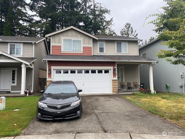 view of front facade with board and batten siding, concrete driveway, a front yard, stone siding, and an attached garage