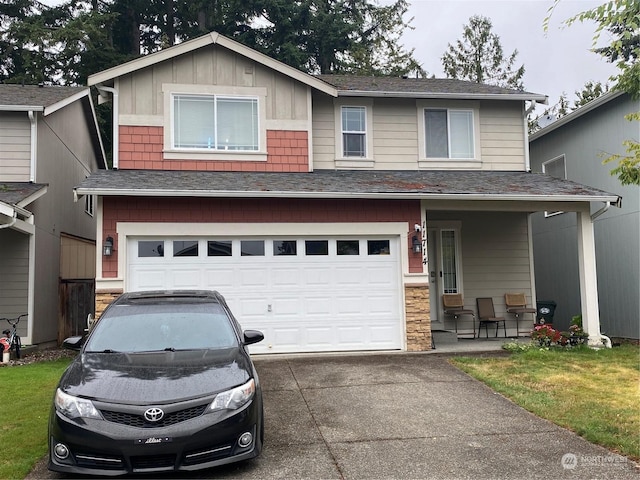 11714 9th Avenue Ct E, Tacoma, WA 98445 - view of front facade with board and batten siding, a shingled roof, a garage, stone siding, and driveway