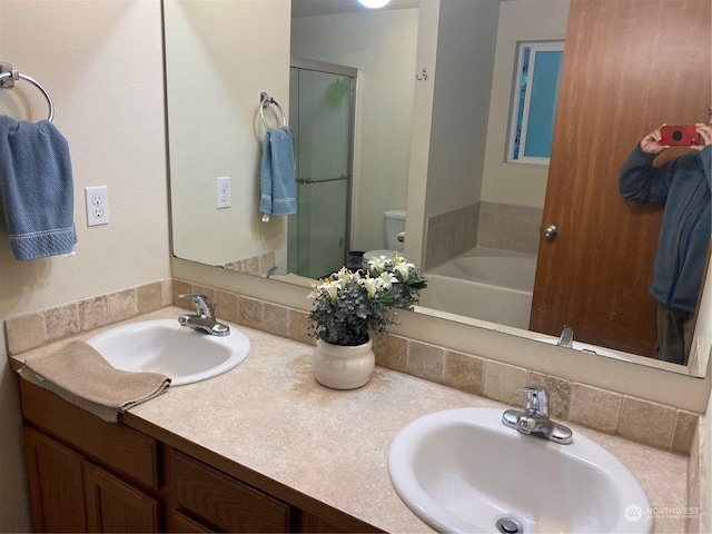 11714 9th Avenue Ct E, Tacoma, WA 98445 - bathroom featuring double vanity, toilet, a stall shower, and a sink