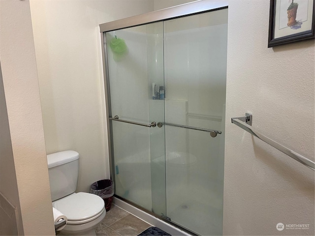 11714 9th Avenue Ct E, Tacoma, WA 98445 - full bathroom with tile patterned flooring, toilet, and a stall shower