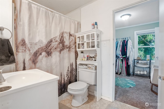 bathroom with ornamental molding, curtained shower, vanity, and toilet