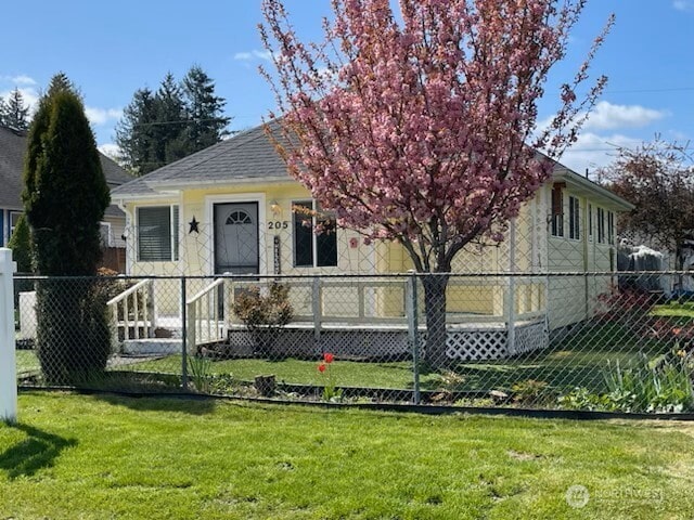 205 Monroe St, Ryderwood, WA 98581 - view of front of house featuring a front yard, a shingled roof, and fence private yard