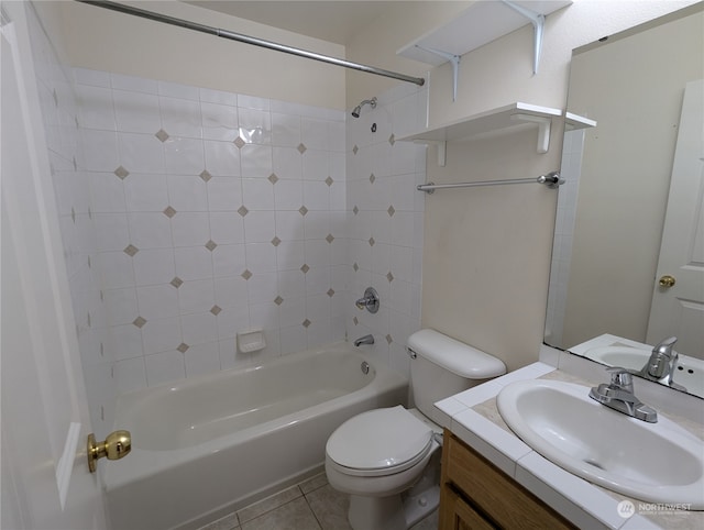 full bathroom featuring tile patterned flooring, toilet, tiled shower / bath combo, and vanity