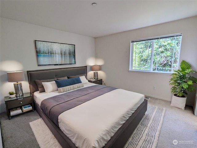 bedroom featuring light carpet