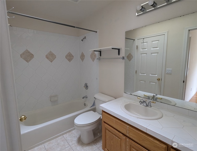 full bathroom featuring tiled shower / bath combo, vanity, toilet, and tile patterned floors