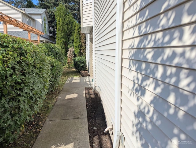 view of side of property with a pergola