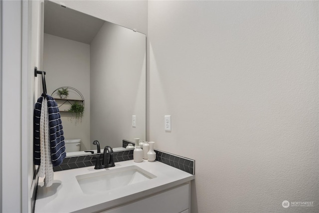 bathroom with toilet and vanity