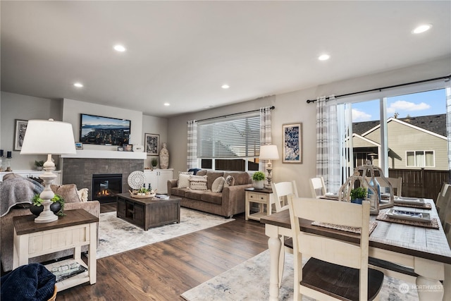 living room with hardwood / wood-style floors and a tile fireplace