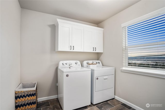 laundry room featuring cabinets and washing machine and clothes dryer