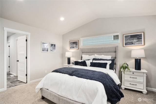 bedroom featuring vaulted ceiling and light colored carpet