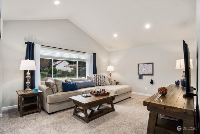 carpeted living room featuring lofted ceiling