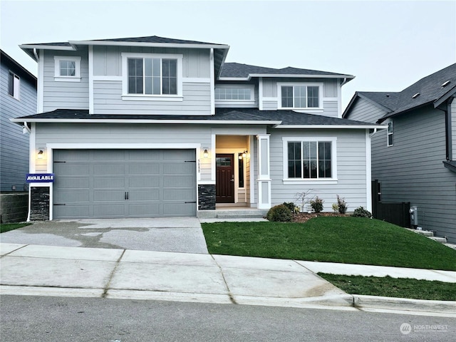 view of front of property with a front lawn and a garage