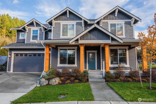 craftsman-style house with a garage, a porch, and a front yard