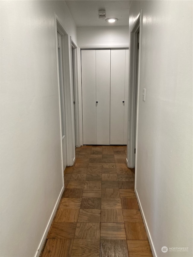 hallway featuring baseboards