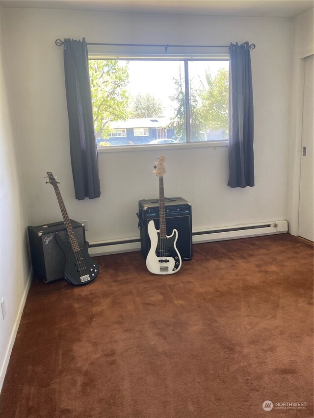 misc room with dark carpet, baseboard heating, and plenty of natural light