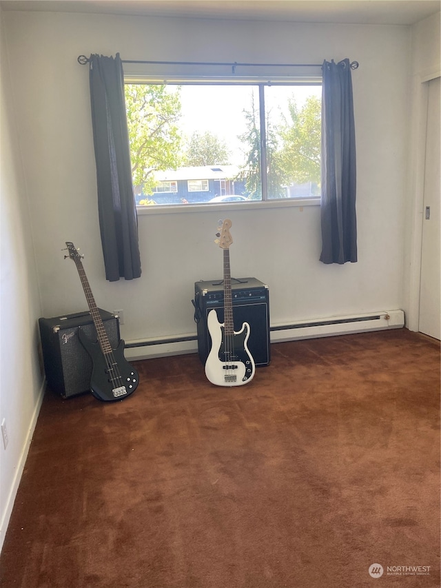 carpeted spare room featuring a baseboard radiator and a baseboard heating unit