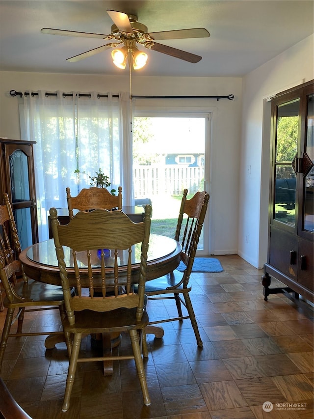 tiled dining area with ceiling fan