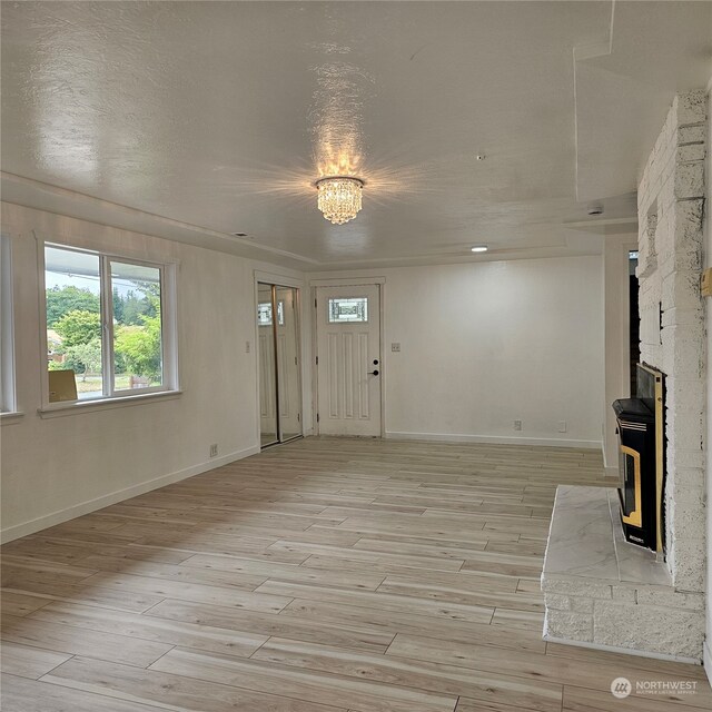 entrance foyer featuring light wood-type flooring and a textured ceiling