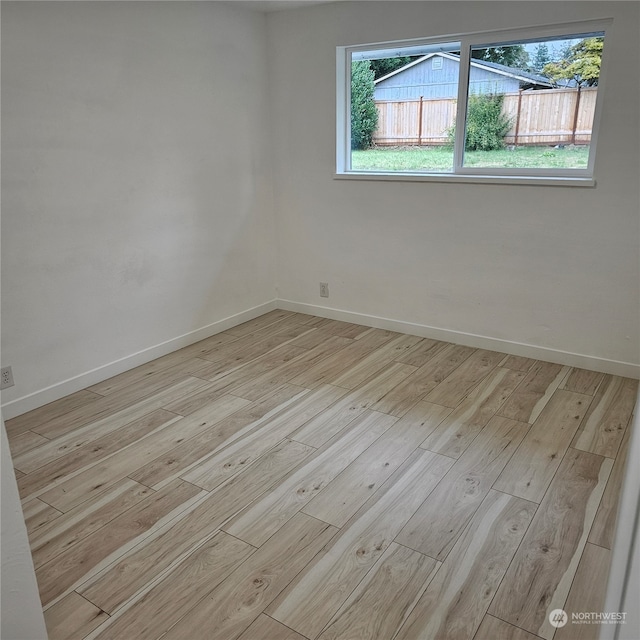 spare room with light wood-type flooring