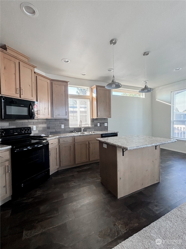 kitchen with decorative light fixtures, black appliances, a kitchen island, sink, and light brown cabinets