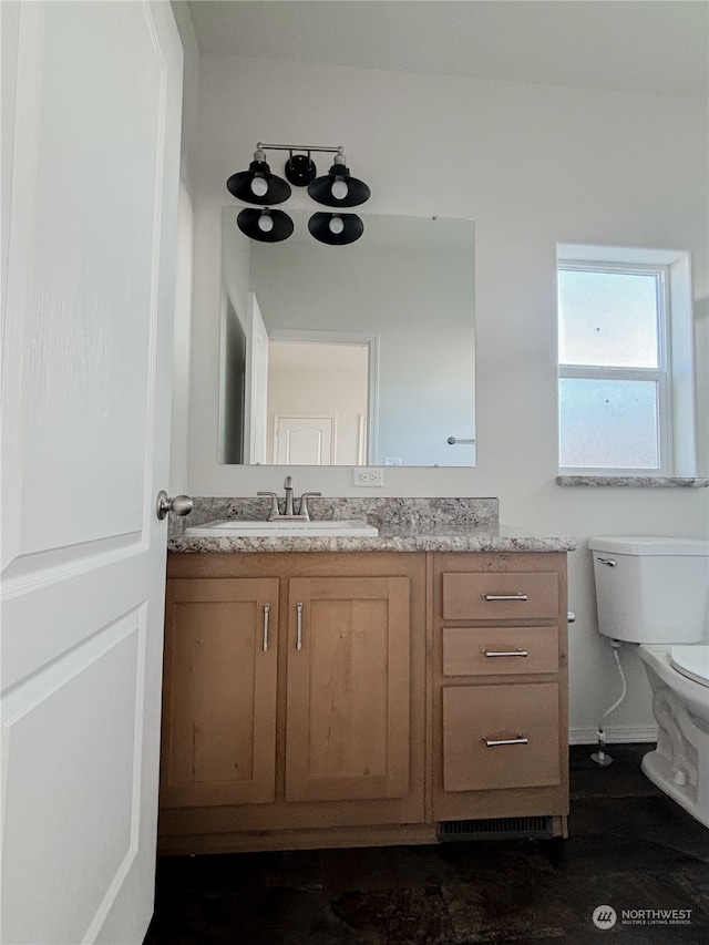 bathroom with vanity and toilet