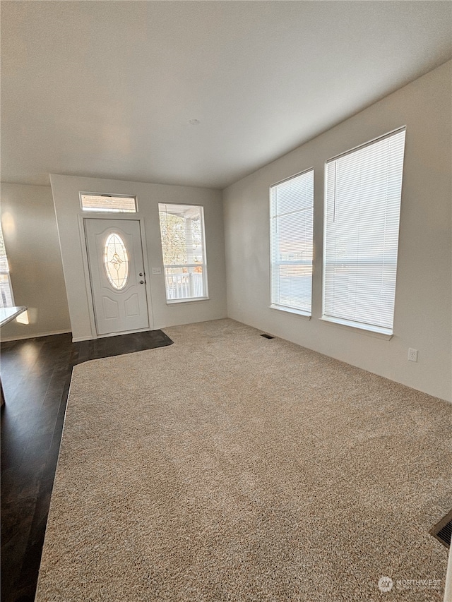 unfurnished living room with dark wood-type flooring