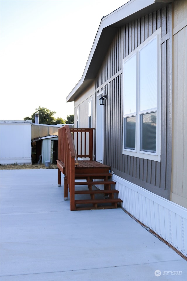 exterior space featuring a storage unit and a patio area