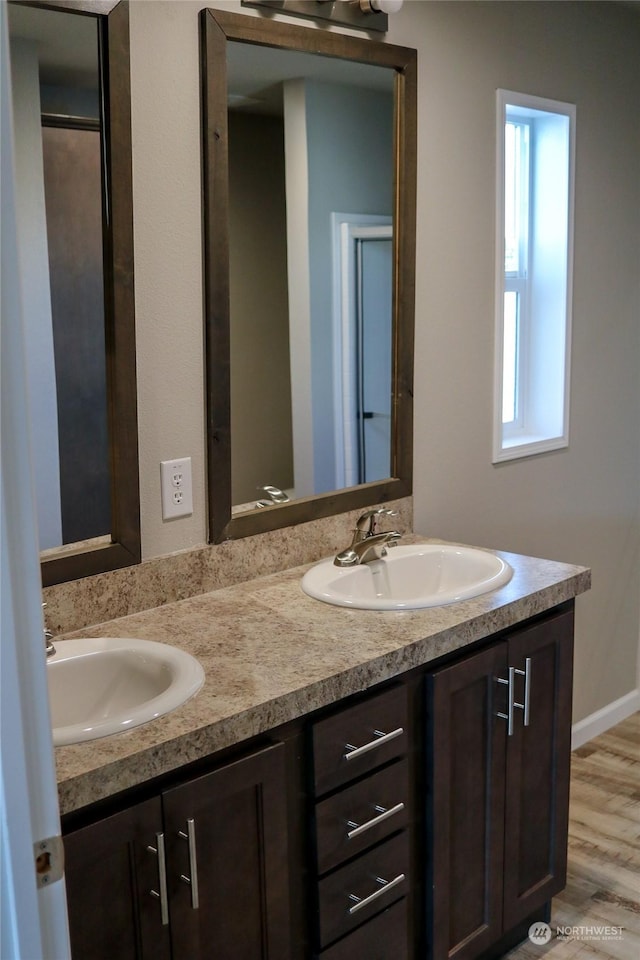 1223 Jones Dr, Walla Walla, WA 99362 - bathroom with a sink, double vanity, and wood finished floors