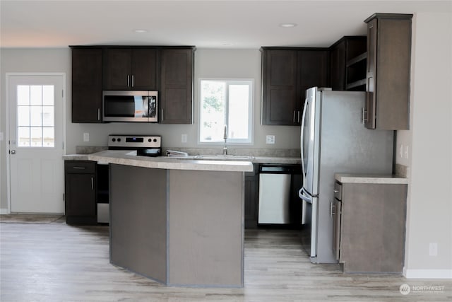 kitchen with a healthy amount of sunlight, light wood-type flooring, and appliances with stainless steel finishes