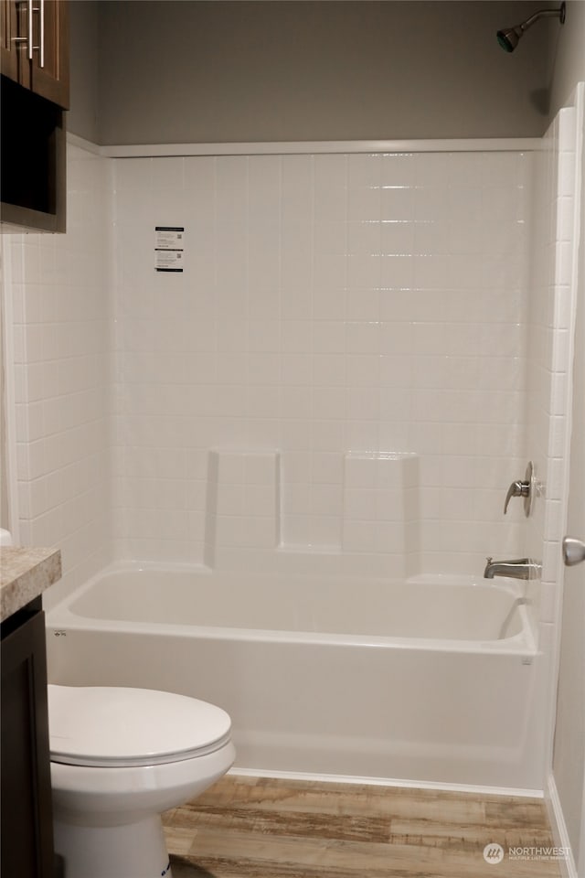 full bathroom featuring toilet, hardwood / wood-style flooring, bathing tub / shower combination, and vanity