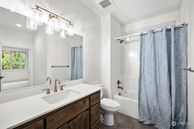 full bathroom with hardwood / wood-style flooring, vanity, shower / bathtub combination with curtain, and toilet