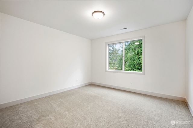 empty room featuring light carpet