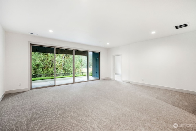 unfurnished room with light carpet