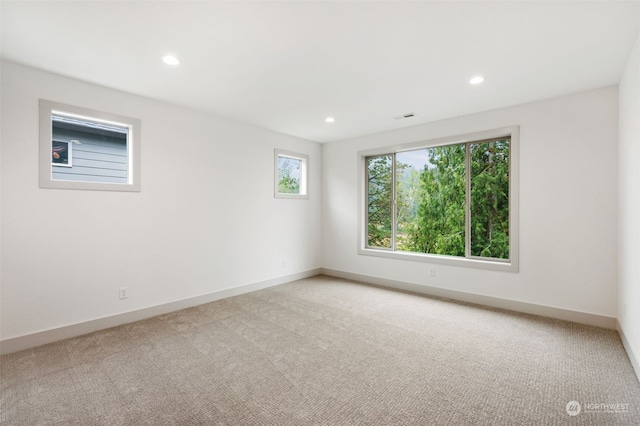 unfurnished room with light colored carpet