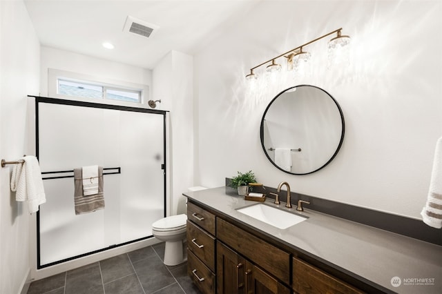 bathroom with tile patterned floors, toilet, walk in shower, and vanity