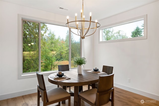 dining room featuring hardwood / wood-style flooring and an inviting chandelier