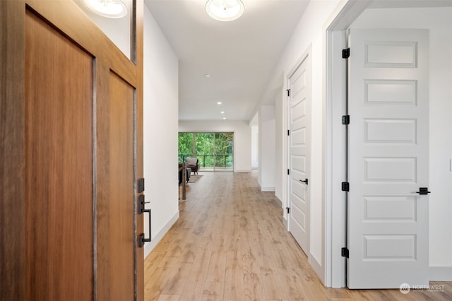 corridor with light hardwood / wood-style floors