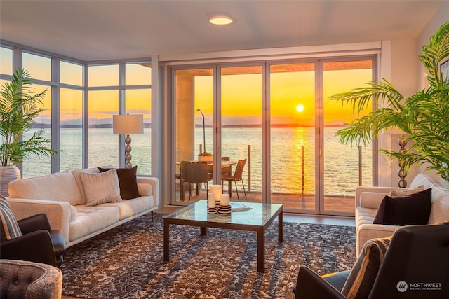 interior space featuring a water view and a wall of windows