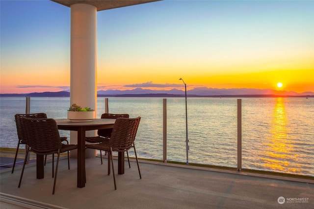 balcony featuring a water and mountain view