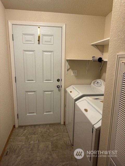 washroom with washing machine and clothes dryer