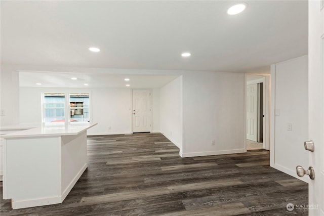 spare room featuring baseboards, dark wood-style flooring, and recessed lighting