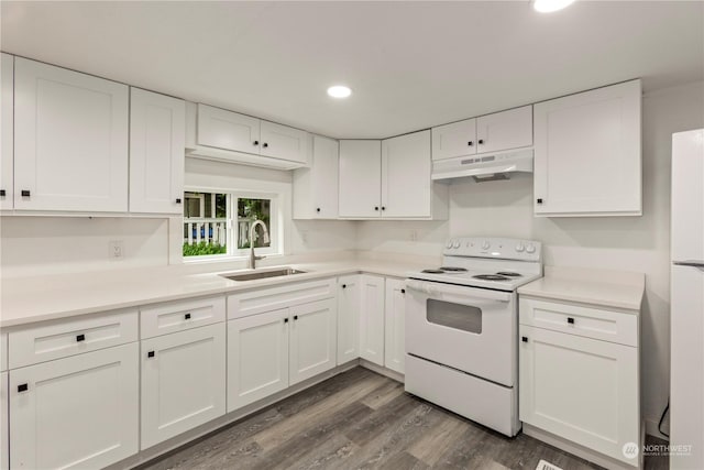 kitchen featuring white range with electric cooktop, dark wood-type flooring, white cabinets, a sink, and under cabinet range hood